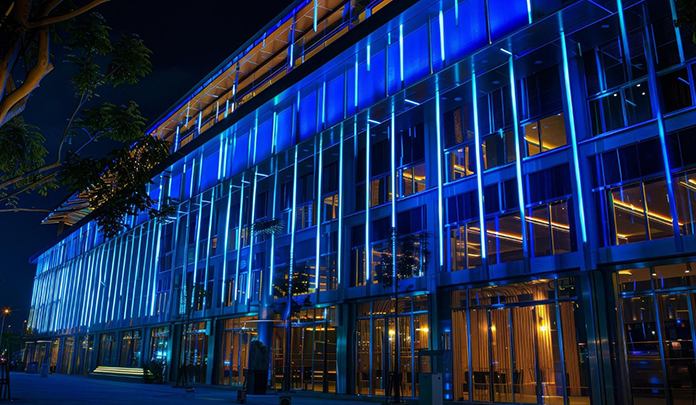 Facade lighting design illuminating modern building exterior with LED architectural lighting for commercial spaces