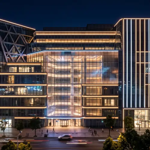 Modern office building with elegant facade lighting design featuring warm white LED linear lights and illuminated architectural exterior at night.